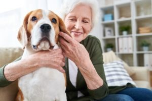 Happy Senior Woman Hugging Dog